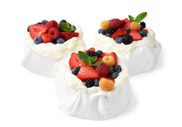 Photo of Pavlova cake (meringue dessert) with whipped cream, fresh berries and mint isolated on white