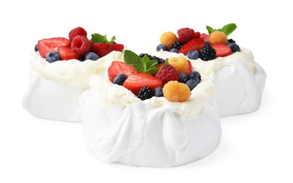 Photo of Pavlova cake (meringue dessert) with whipped cream, fresh berries and mint isolated on white