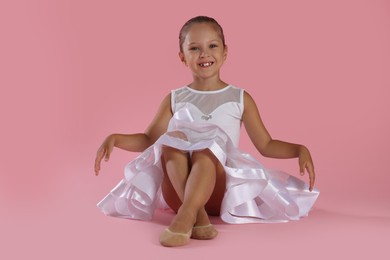 Photo of Portrait of little ballerina on pink background