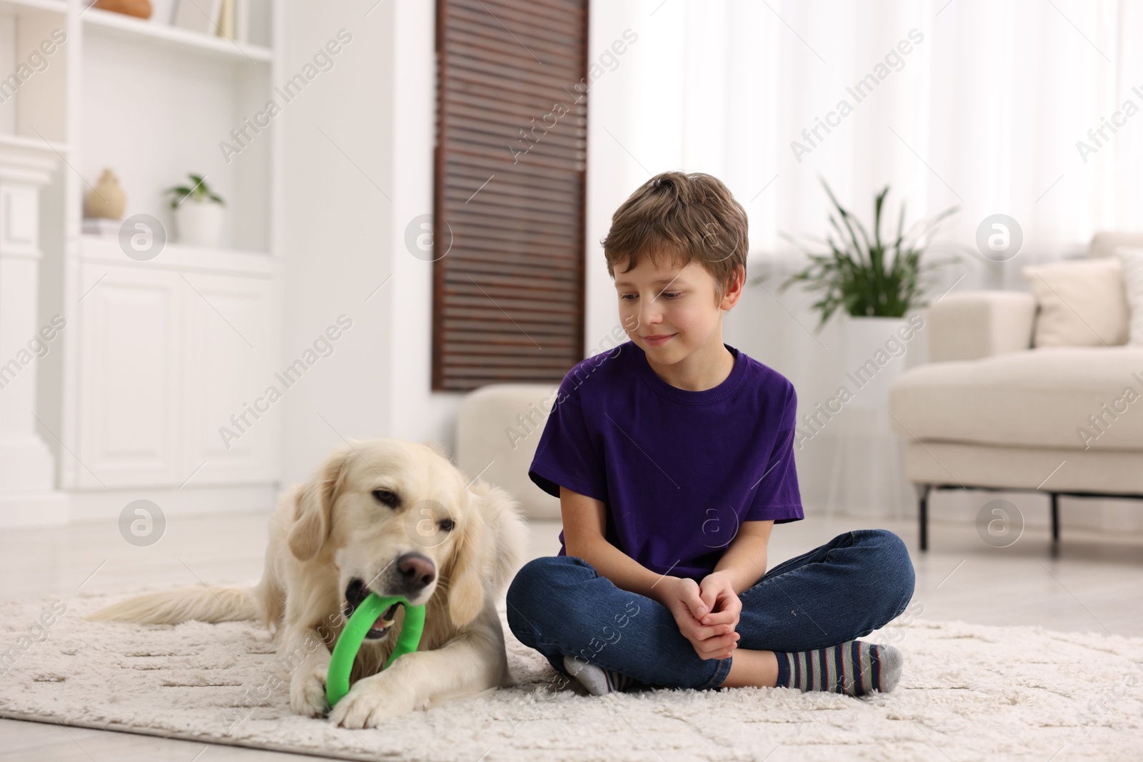 Photo of Boy with his cute dog at home