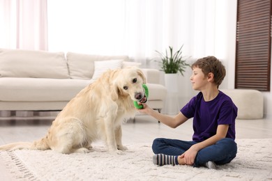 Photo of Boy playing with his cute dog at home