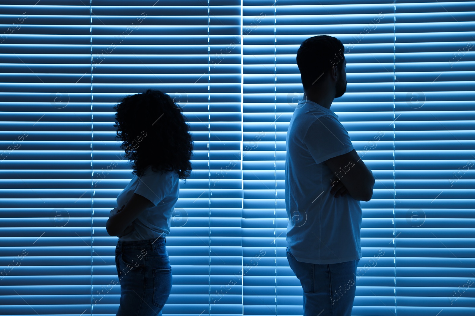 Photo of Couple having quarrel indoors at night. Relationship problems