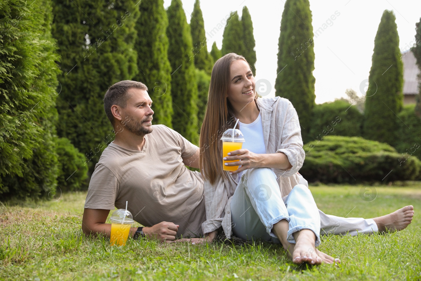 Photo of Couple spending time together on green lawn in park