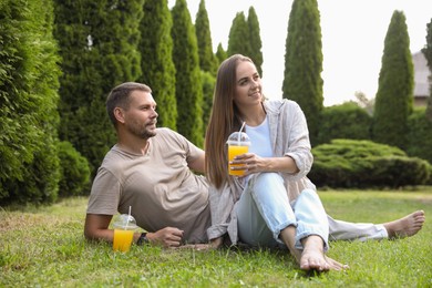 Couple spending time together on green lawn in park