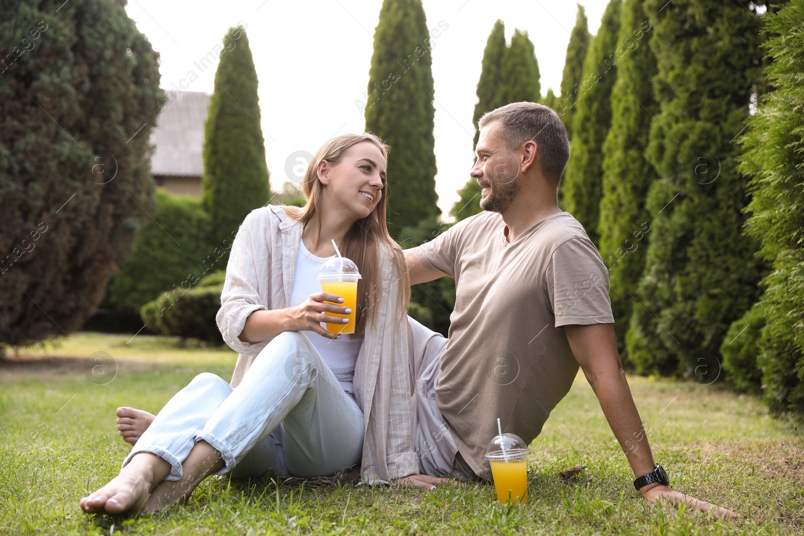 Photo of Couple spending time together on green lawn in park