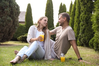 Couple spending time together on green lawn in park