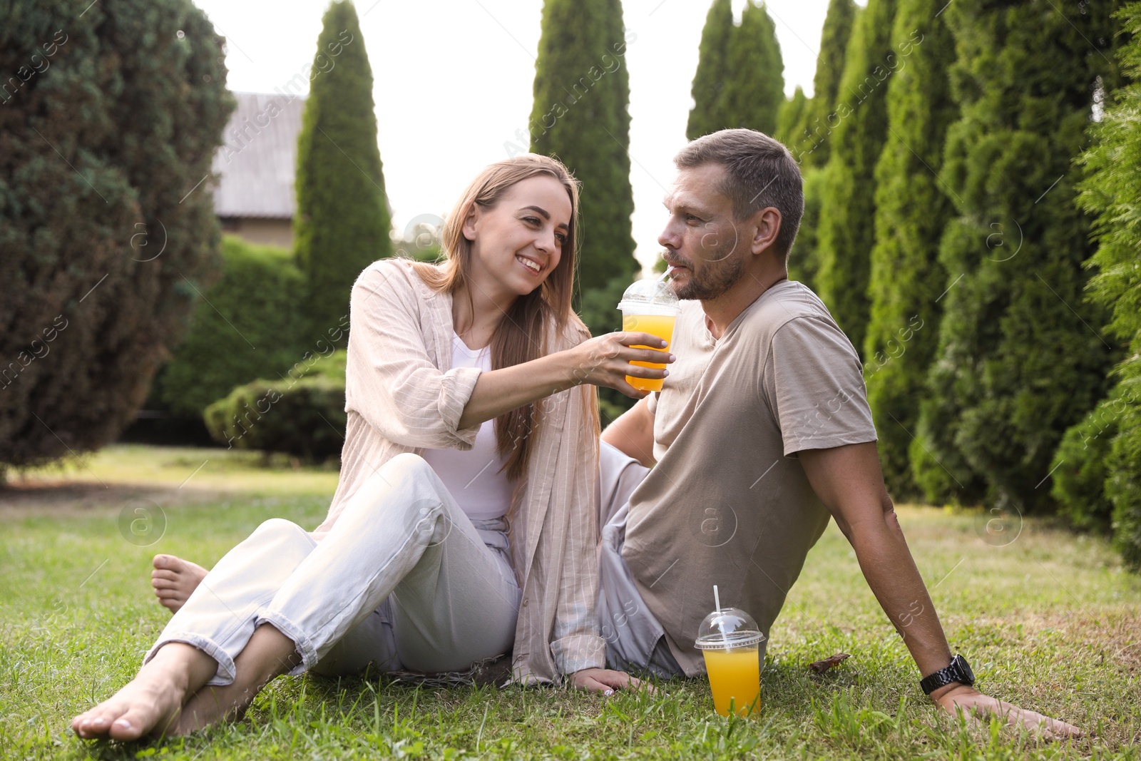 Photo of Couple spending time together on green lawn in park