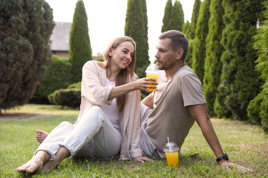 Photo of Couple spending time together on green lawn in park