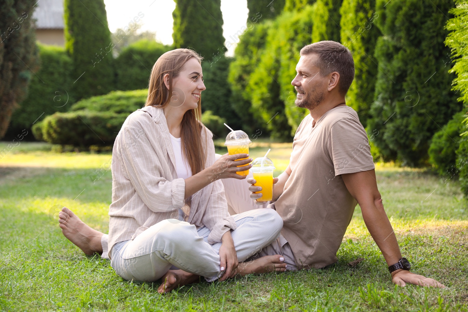 Photo of Couple spending time together on green lawn in park