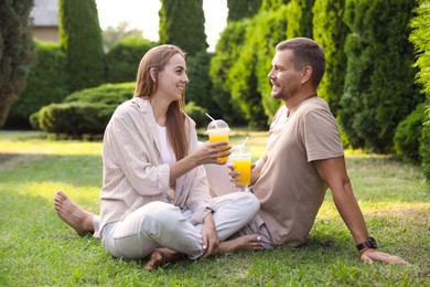 Couple spending time together on green lawn in park