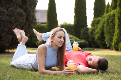 Couple spending time together on green lawn in park