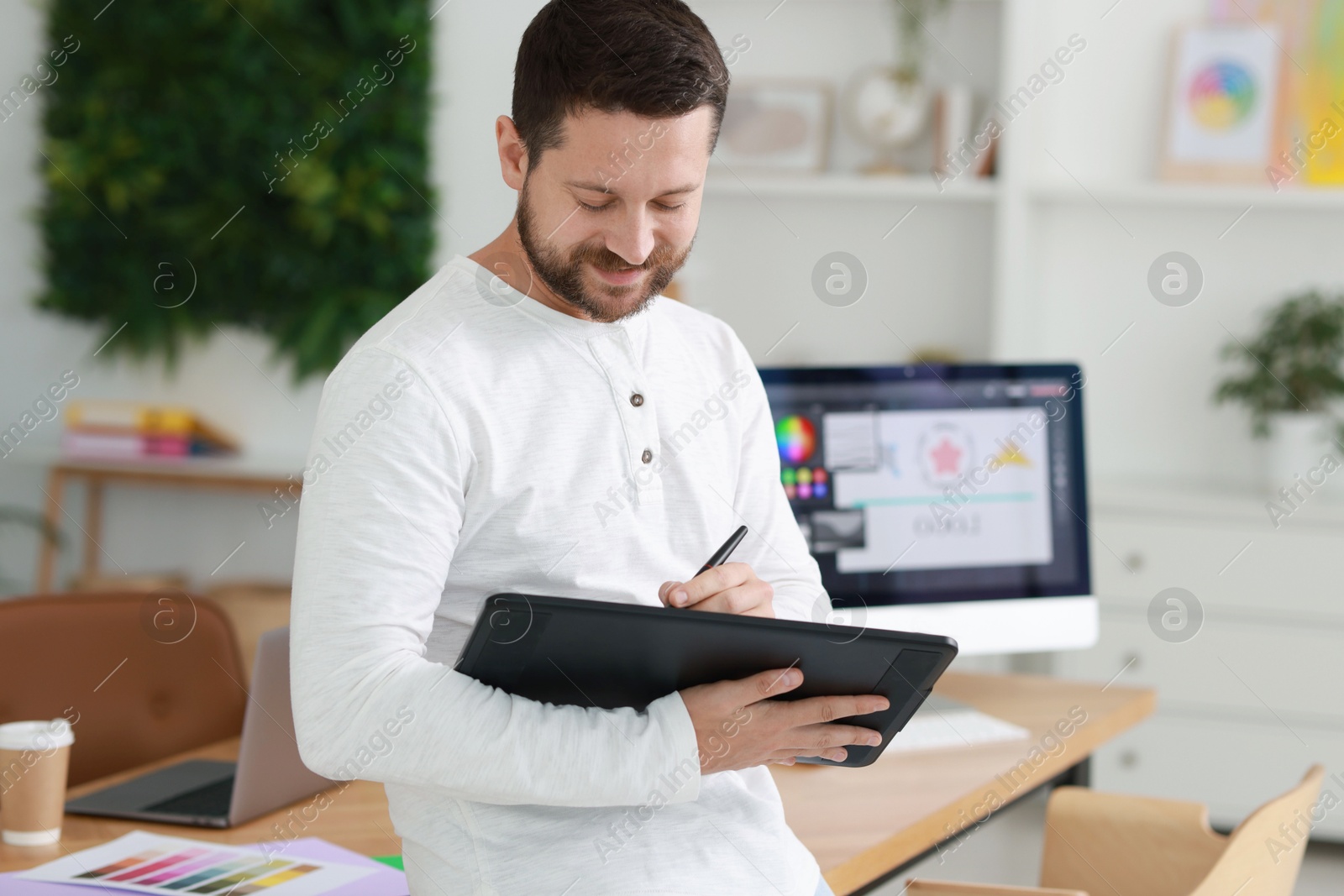 Photo of Professional designer with tablet in modern office