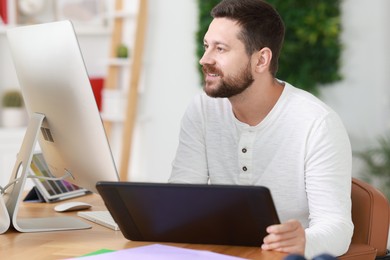 Designer working with tablet at table in office