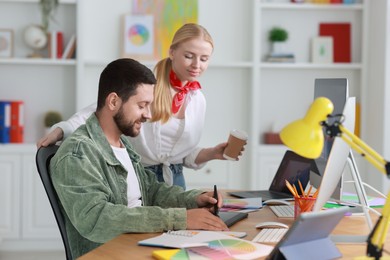 Designers working at table together in office