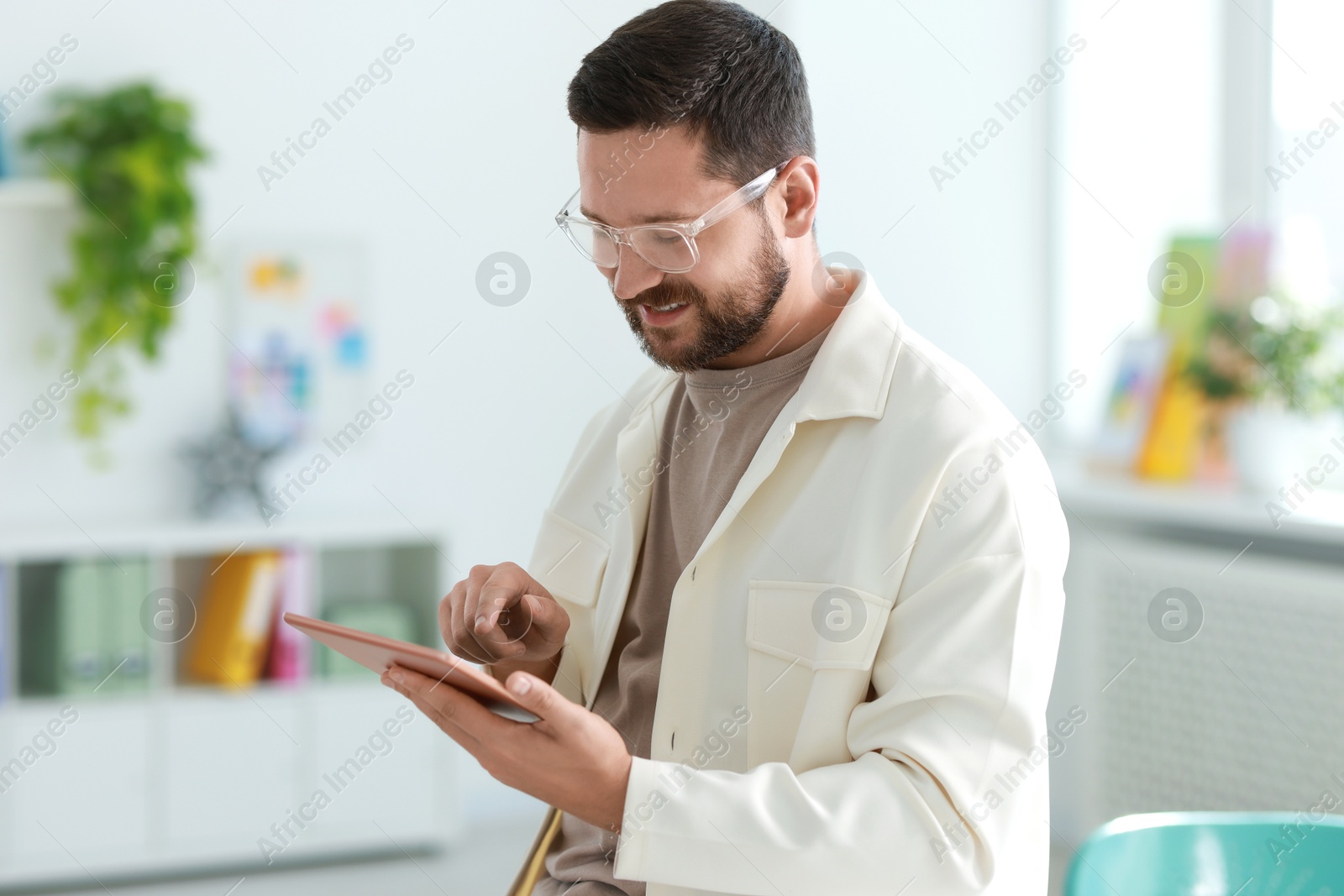 Photo of Smiling designer with tablet working in office