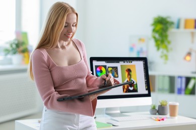 Young designer working with tablet in office