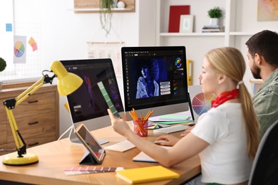 Designers working together at table in office