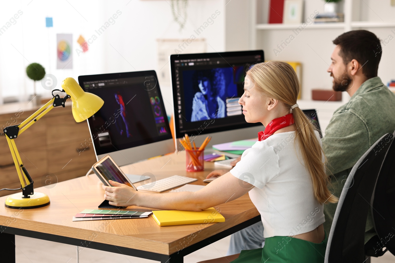 Photo of Designers working together at table in office