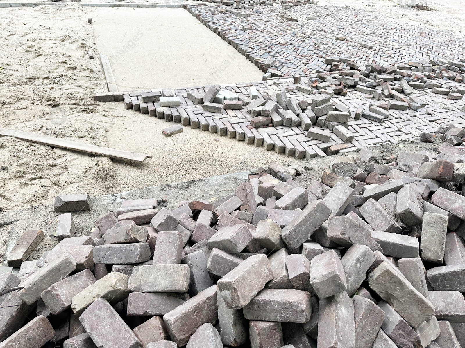 Photo of Process of laying paving stone blocks outdoors