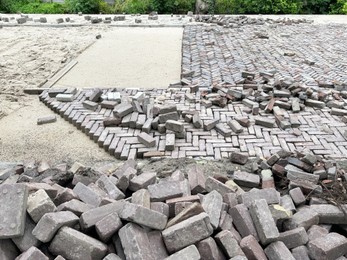 Photo of Process of laying paving stone blocks outdoors