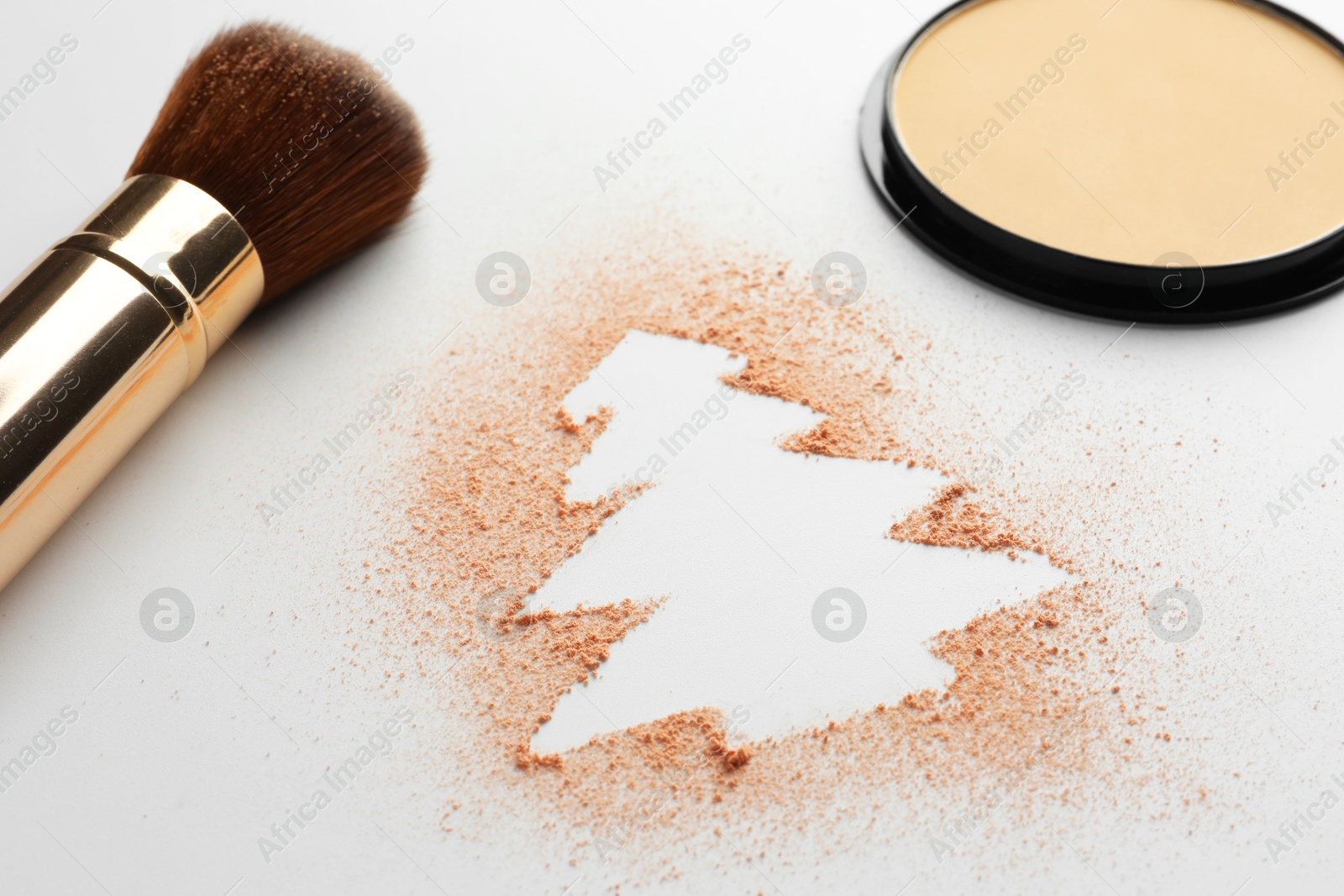 Photo of Christmas tree made of powder and makeup brush on white background, closeup