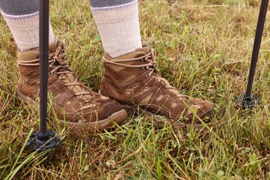 Photo of Young hiker with trekking poles outdoors, closeup