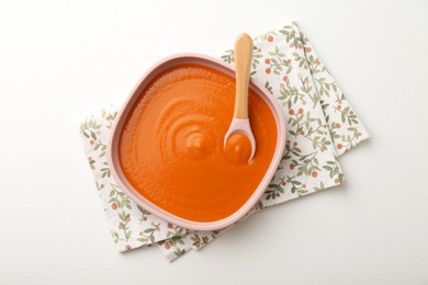 Photo of Delicious baby food in bowl on white table, top view