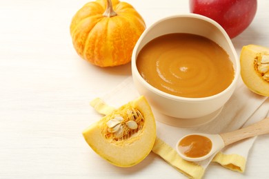 Photo of Delicious baby food in bowl and fresh ingredients on white wooden table