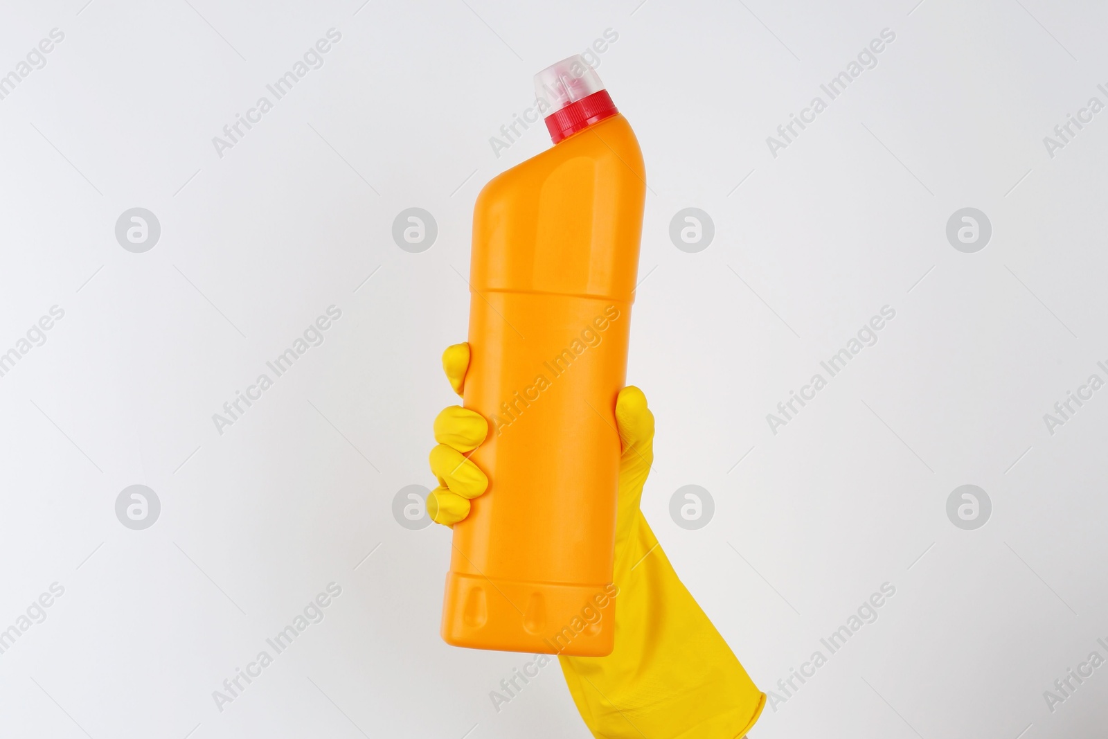 Photo of Woman holding toilet cleaner in bottle on light background, closeup