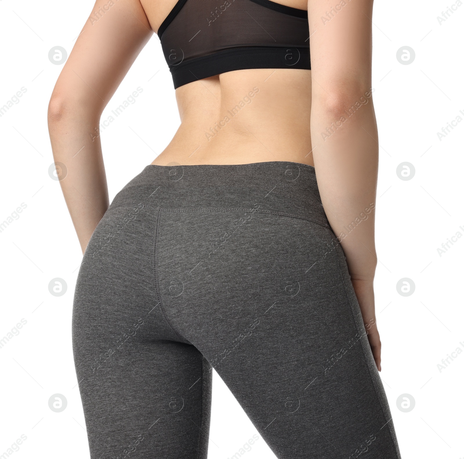 Photo of Woman wearing sports leggings and bra on white background, closeup