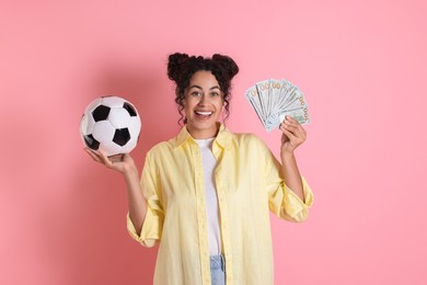 Photo of Happy woman with money and soccer ball on pink background