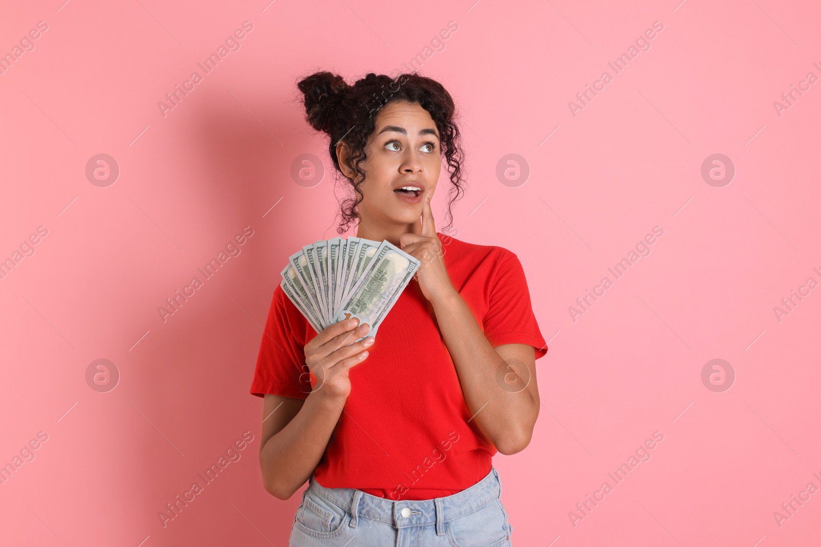 Photo of Woman with dollar banknotes on pink background