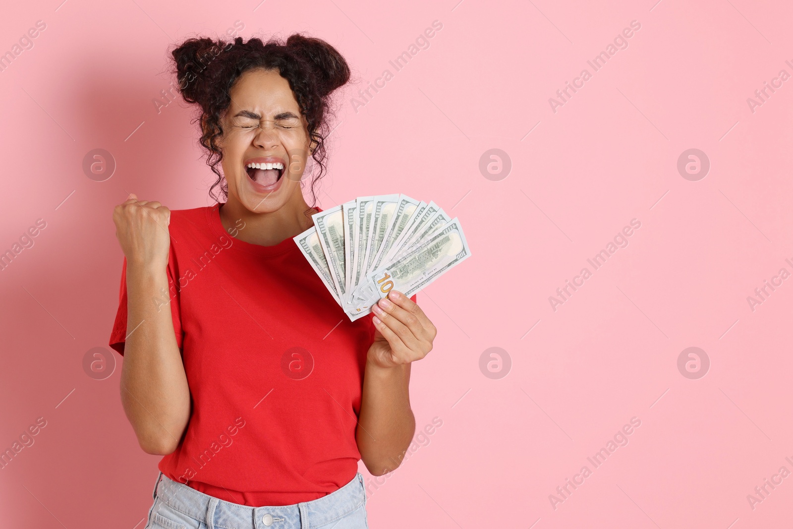 Photo of Happy woman with dollar banknotes on pink background, space for text