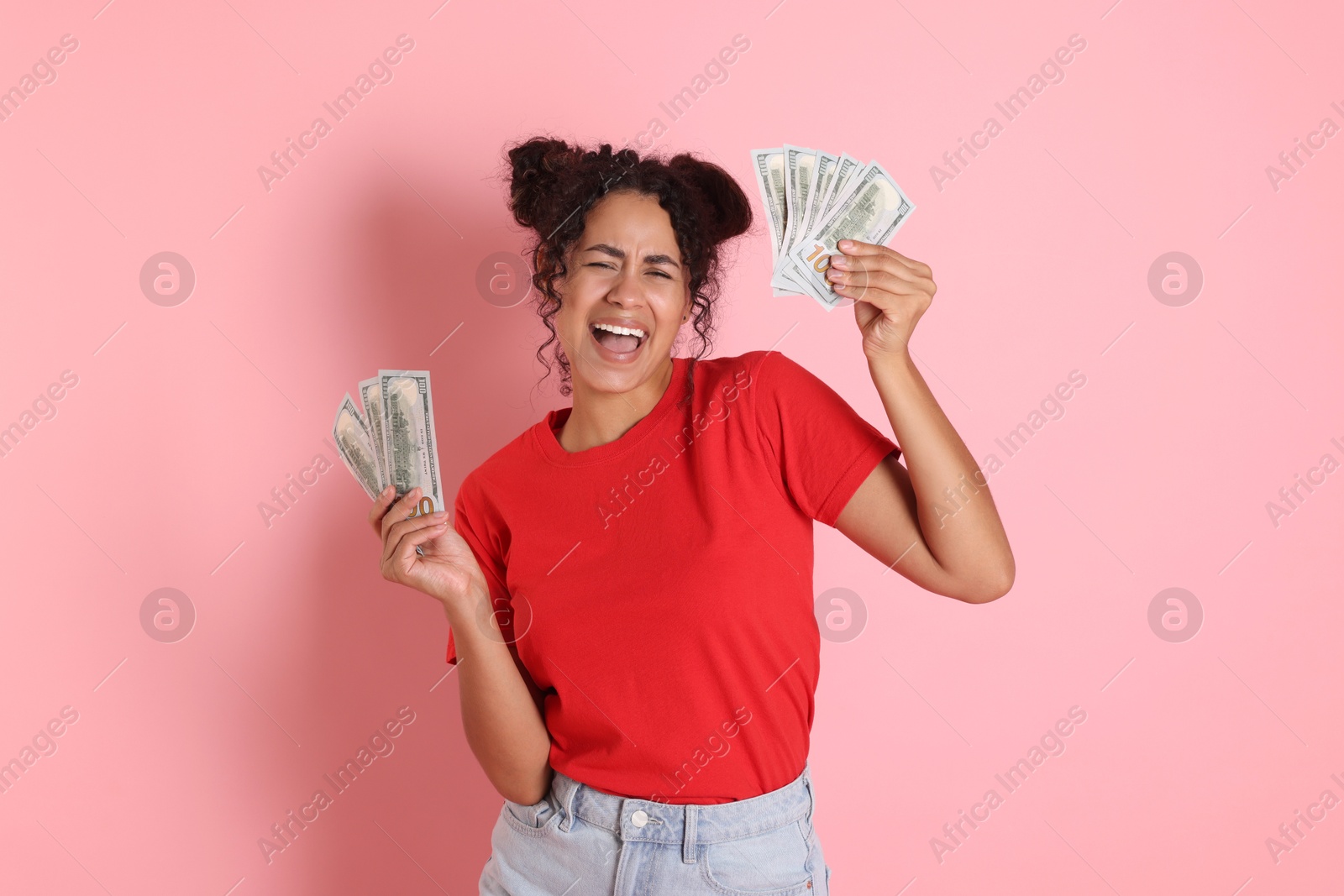 Photo of Happy woman with dollar banknotes on pink background