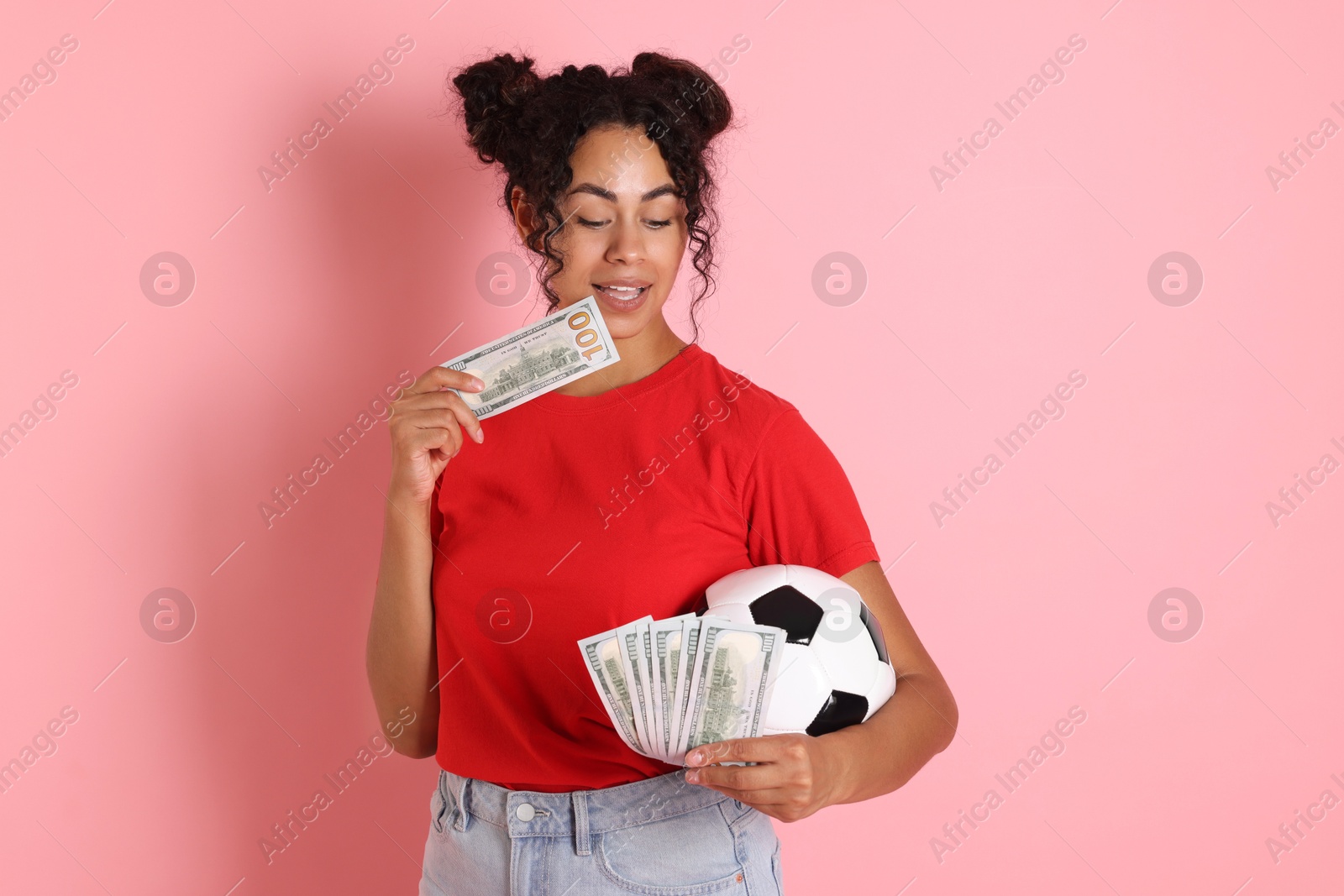 Photo of Woman with money and soccer ball on pink background