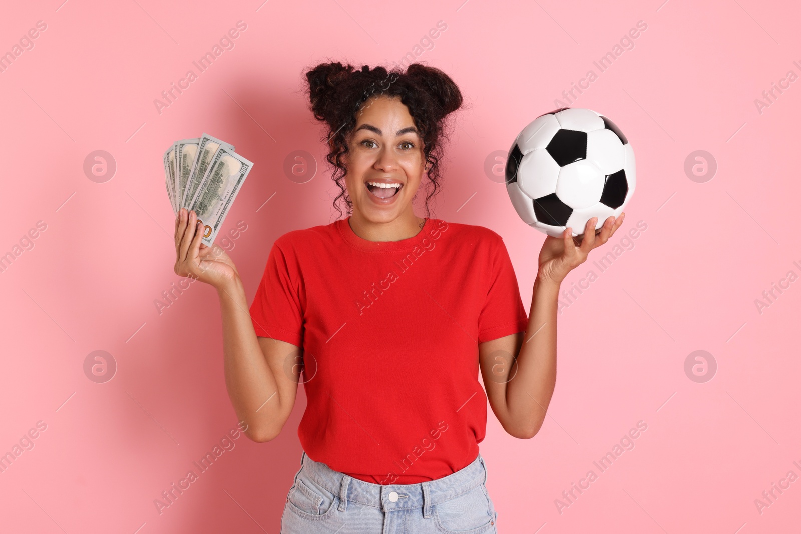 Photo of Happy woman with money and soccer ball on pink background