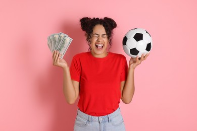 Photo of Happy woman with money and soccer ball on pink background