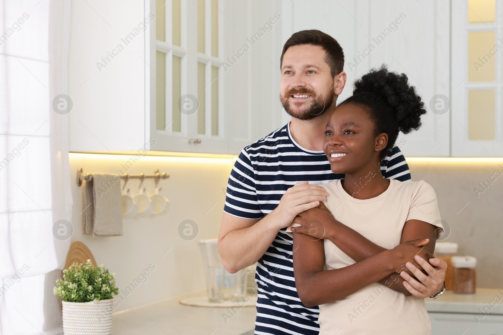 Photo of International relationships. Portrait of lovely couple in kitchen