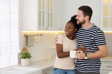 Photo of International relationships. Portrait of lovely couple in kitchen