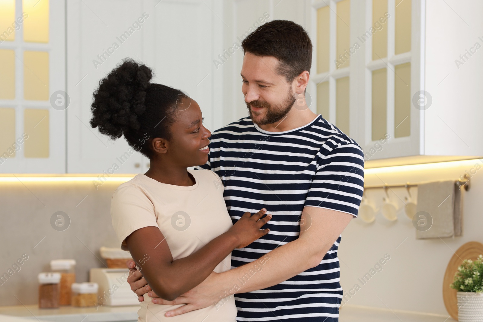 Photo of International relationships. Portrait of lovely couple in kitchen