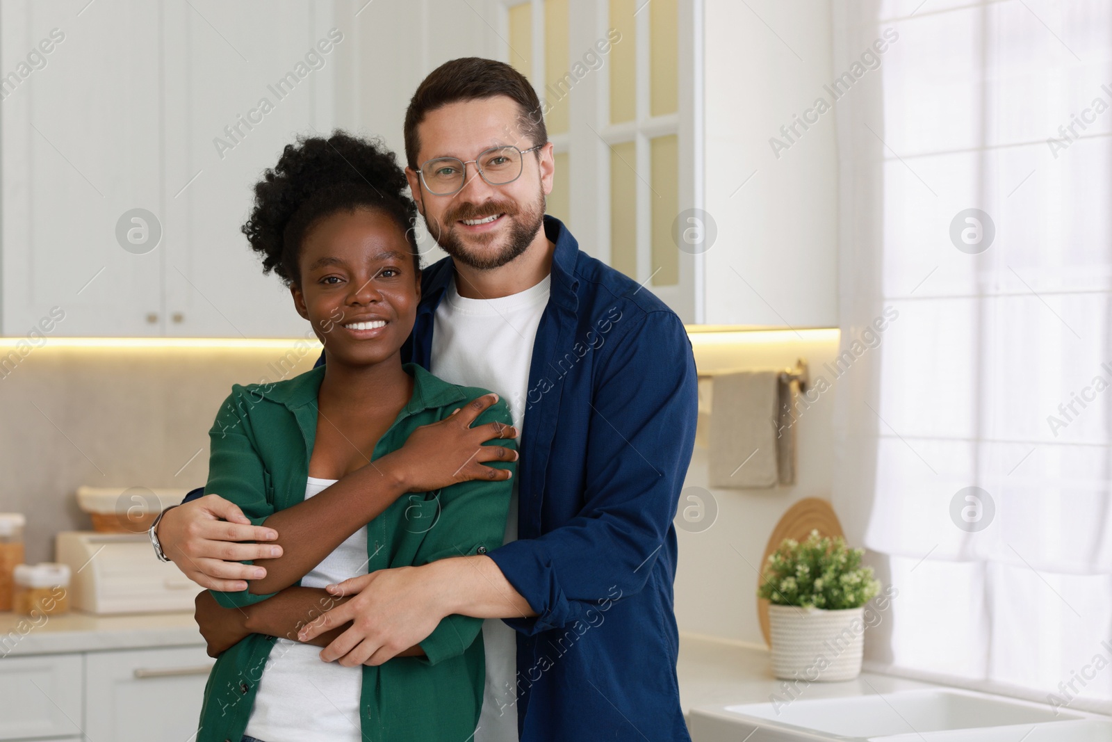 Photo of International relationships. Portrait of lovely couple in kitchen