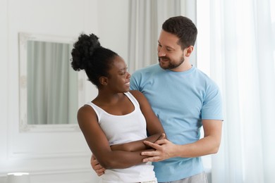 Photo of International relationships. Portrait of lovely couple at home