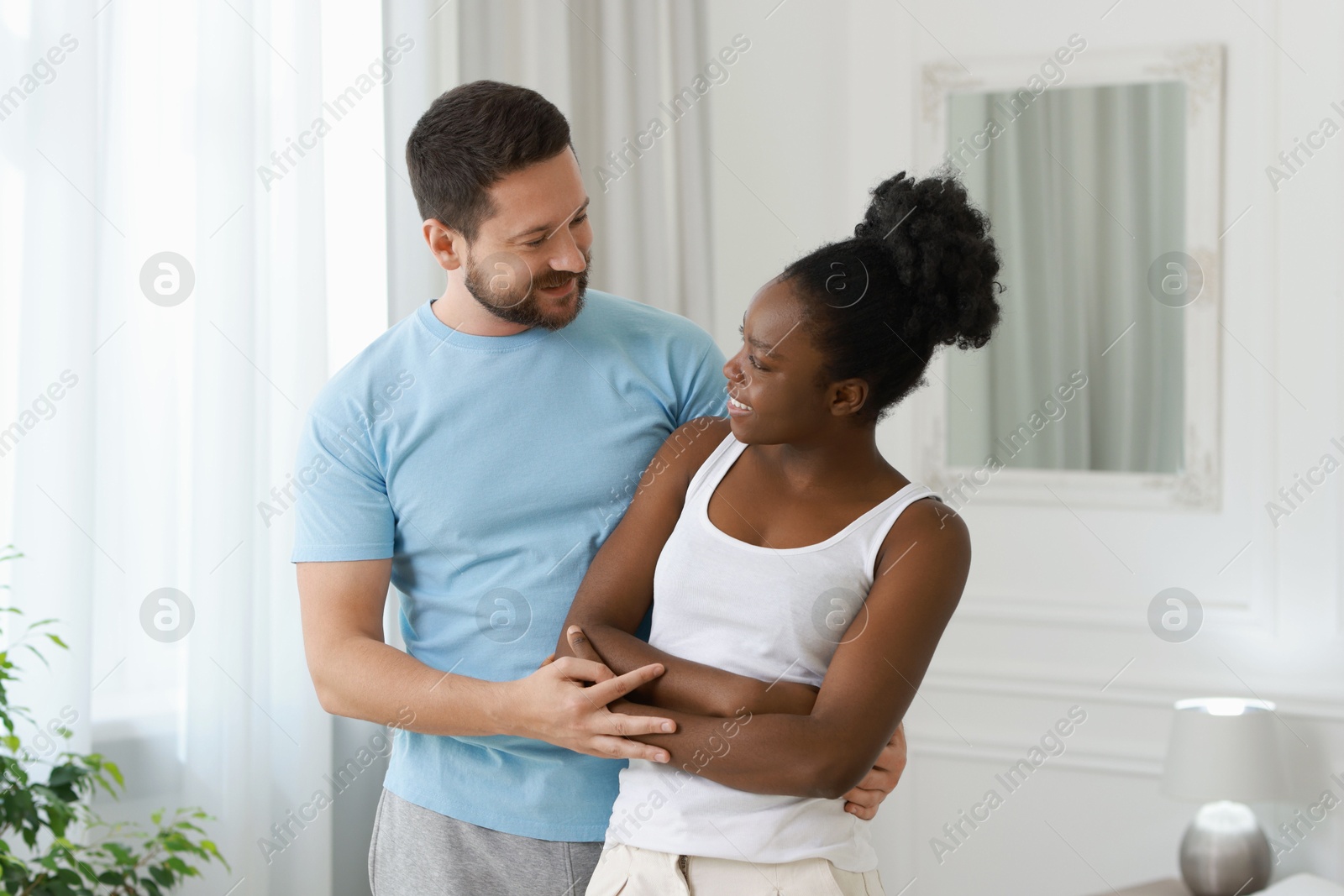 Photo of International relationships. Portrait of lovely couple at home