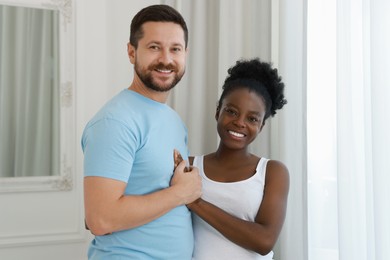 International relationships. Portrait of lovely couple at home