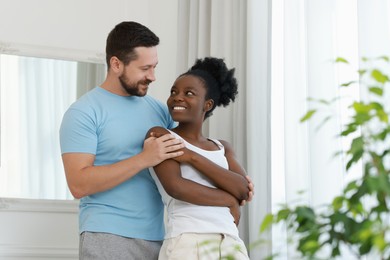 International relationships. Portrait of lovely couple at home