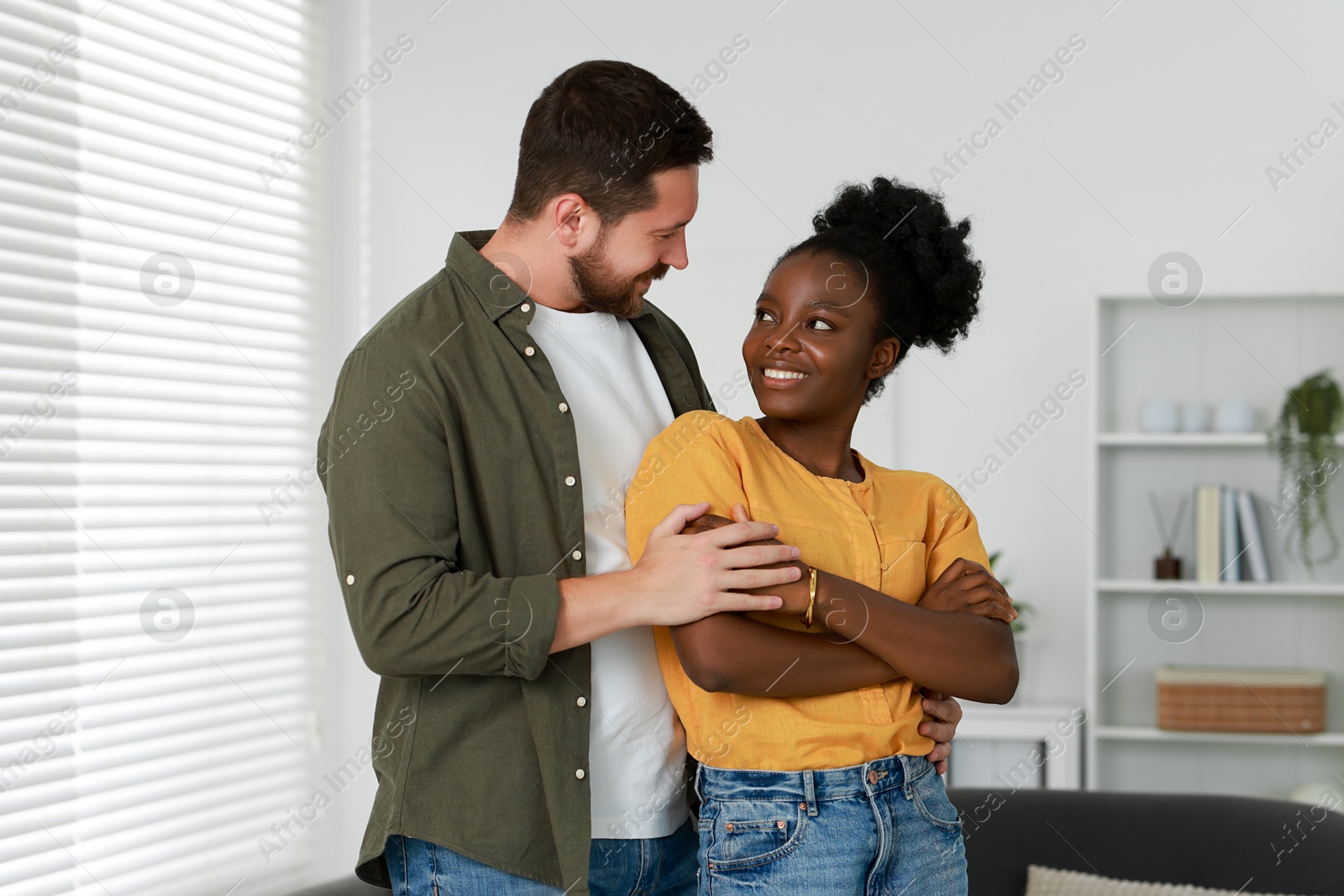 Photo of International relationships. Portrait of lovely couple at home