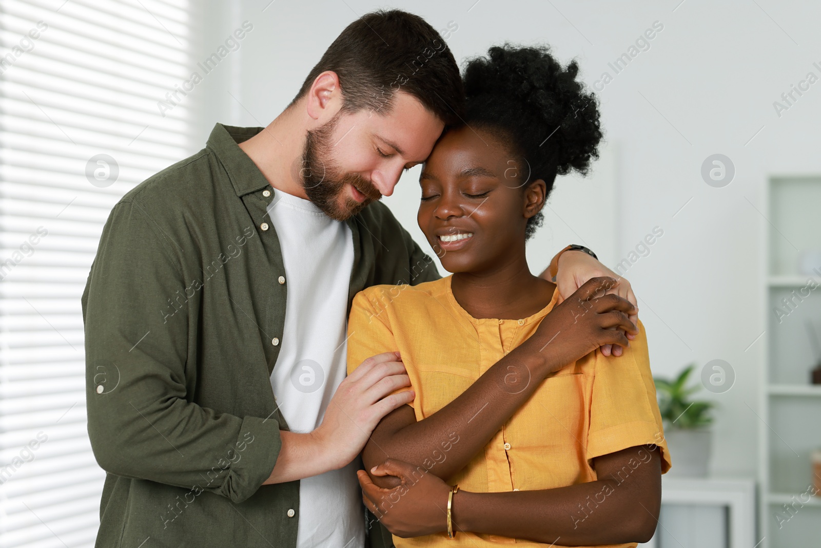 Photo of International relationships. Portrait of lovely couple at home