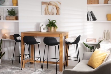 Bar stools near table in room. Interior design