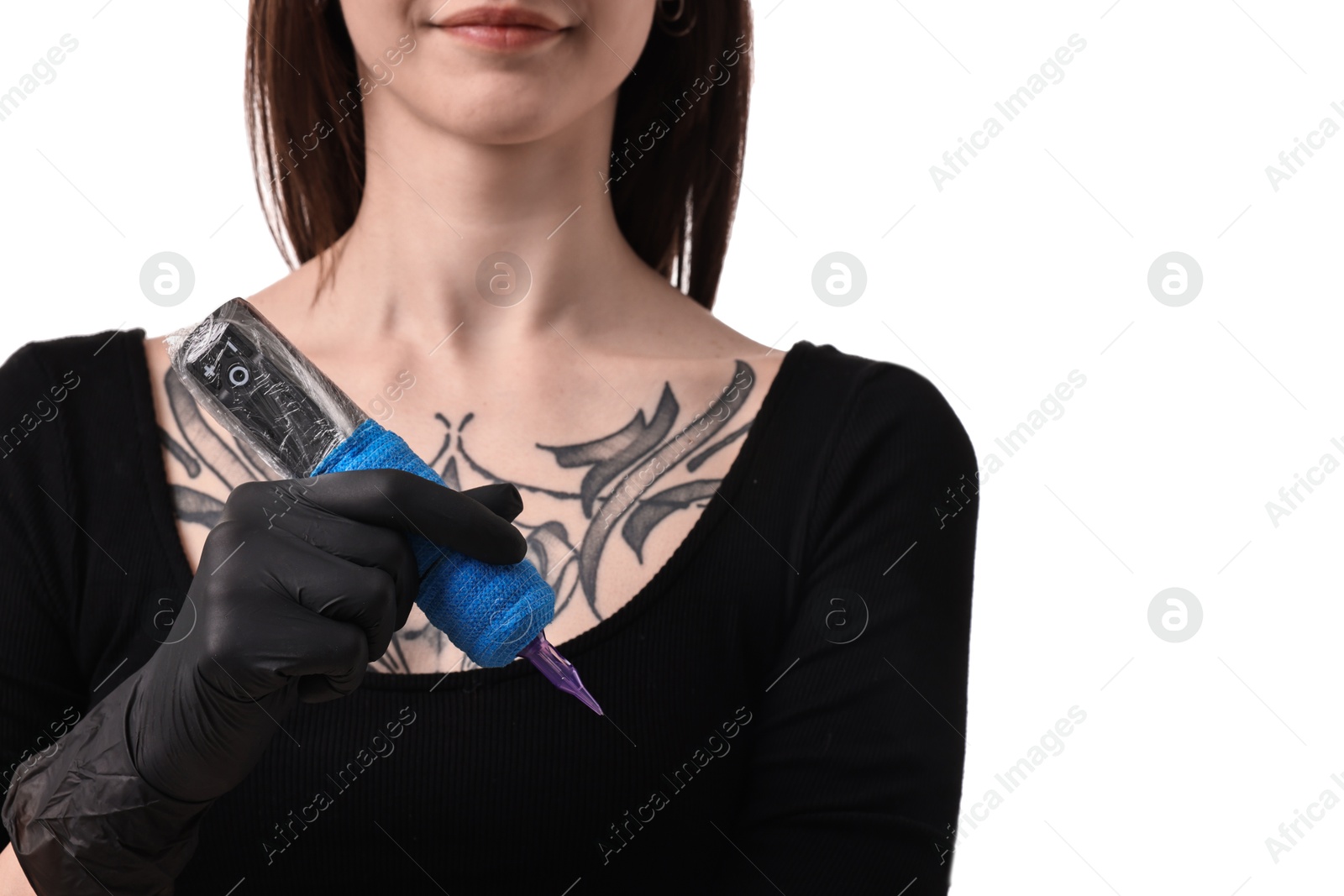 Photo of Professional artist in gloves holding tattoo machine on white background, closeup