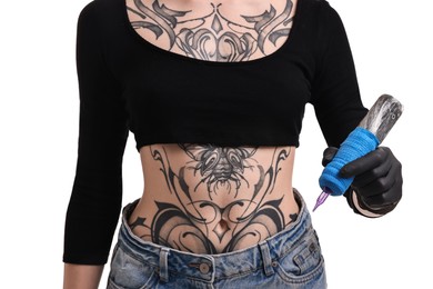 Photo of Professional artist in gloves holding tattoo machine on white background, closeup